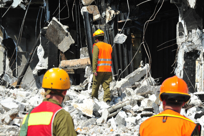 Construction workers work on disaster planning for their construction site.